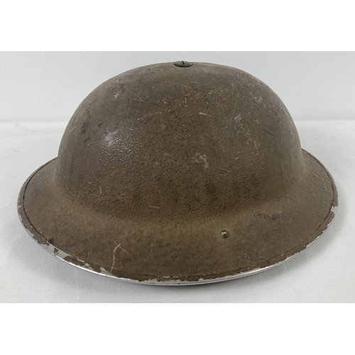 1116 - A British MkI steel helmet stamped FKS48, with 1939 liner and chinstrap. Field applied roughened kha... 