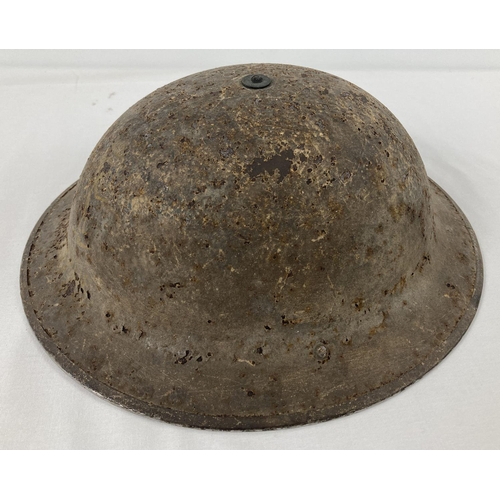 1118 - A WWII British Mk II steel helmet with field applied brown camouflage finish. Smooth khaki factory p... 