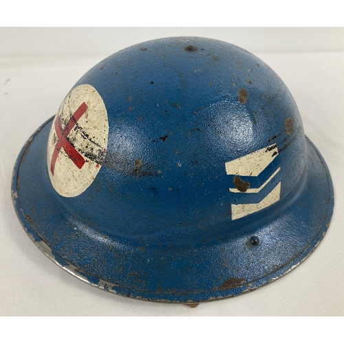 1120 - A WWII British Mk II steel helmet, painted blue. With red cross and rank marking for Corporal in RAF... 