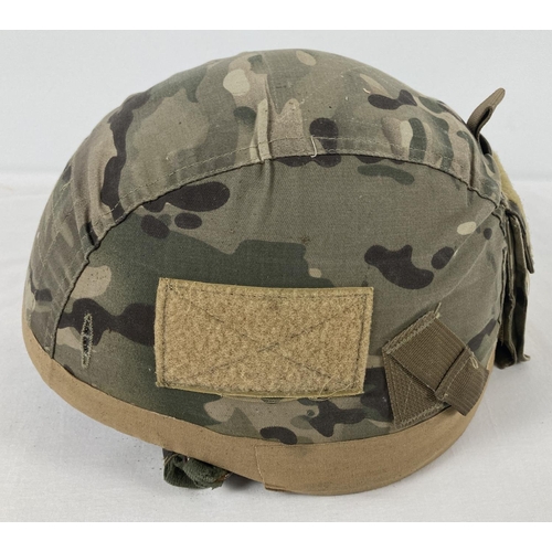 1123 - A British 1999 lightweight Paratroop helmet, size medium. With camouflage cover including Velcro pou... 