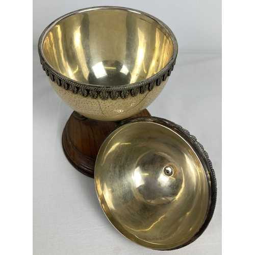 1296 - An antique lidded trinket pot made from an ostrich egg. With silver plated interior, decorative trim... 