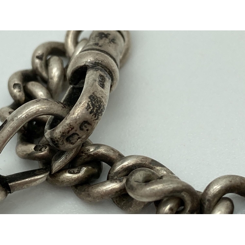 1067 - A vintage silver albert watch chain with lobster claw clasps. Both clasps marked and each curb chain... 