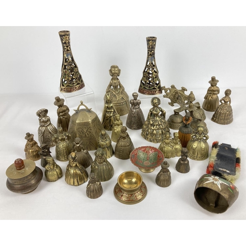 1091 - A quantity of brass character bells, hanging bells and small dishes. To include small decorative wal... 