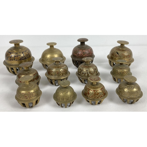 1092 - A collection of 12 Indian elephant temple claw bells. All with engraved detail, in varying sizes.