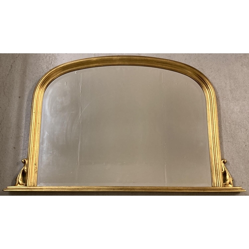 1381 - A large gilt framed over mantle mirror. With curved top and small scroll detail to both sides. Appro... 