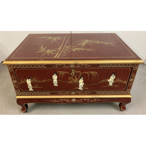 1382 - A oriental design red lacquer small coffee table/ unit with front pull down cupboard and small cabri... 