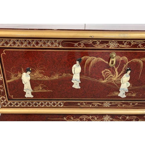 1382 - A oriental design red lacquer small coffee table/ unit with front pull down cupboard and small cabri... 