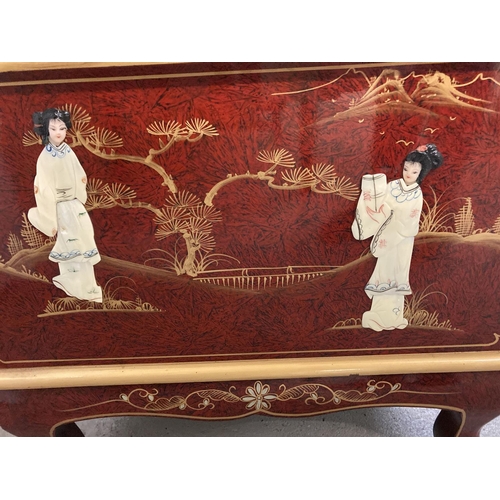 1382 - A oriental design red lacquer small coffee table/ unit with front pull down cupboard and small cabri... 