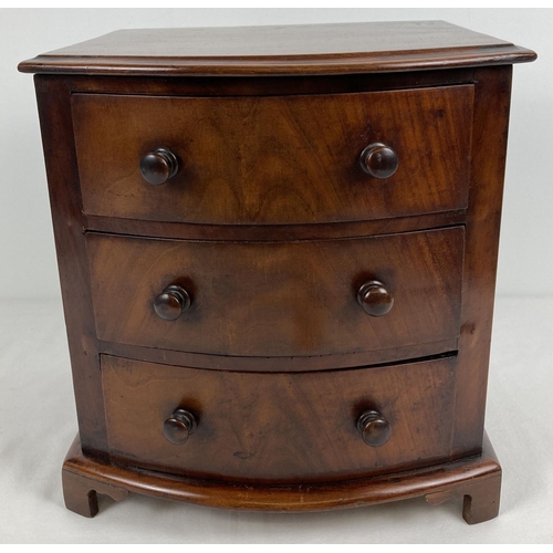 1316 - A vintage mahogany miniature bow fronted 3 drawer chest of drawers with bun handles and shaped feet.... 