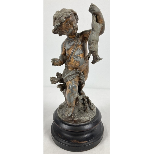 1104 - An antique hollow pewter figurine of a child holding a lamb, mounted on a circular wooden plinth. Sh... 