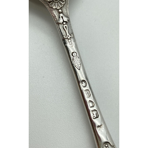 1072 - A decorative Victorian Richard Martin & Ebenezer Hall silver spoon. With ornate detail to handle and... 