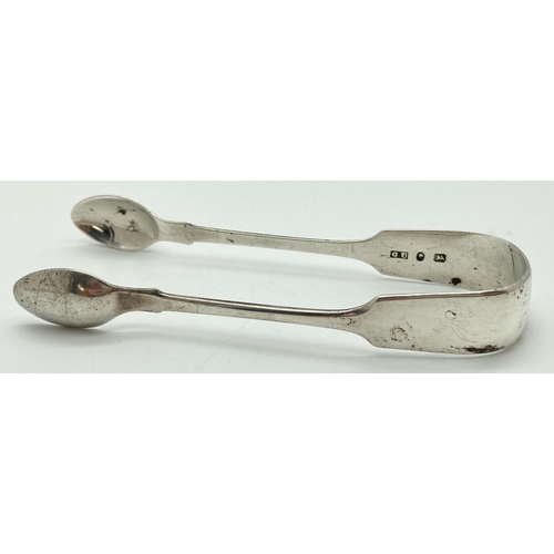 1073 - A pair of Victorian silver sugar tongs Hallmarked Birmingham 1863, with Victoria head mark and Georg... 