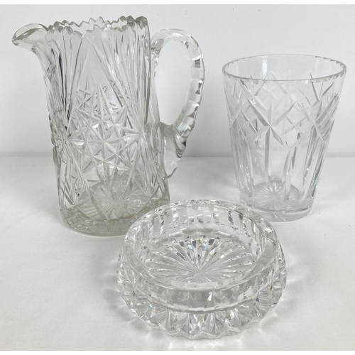 1186 - 3 items of quality cut glass and crystal. A jug with shaped handle, a small vase and a decorative di... 