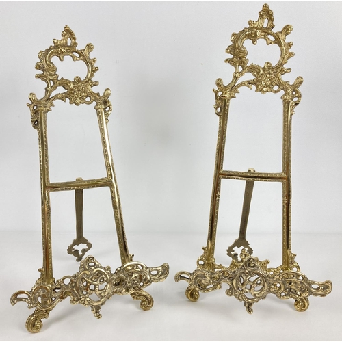 1107 - A pair of decorative brass table top easel stands with fold out supporting foot. Each approx. 41cm t... 