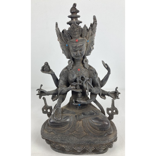 1191 - An Oriental hollow bronze figure of Buddhist Deity Marichi, with 3 faces and 8 arms. Set with small ... 