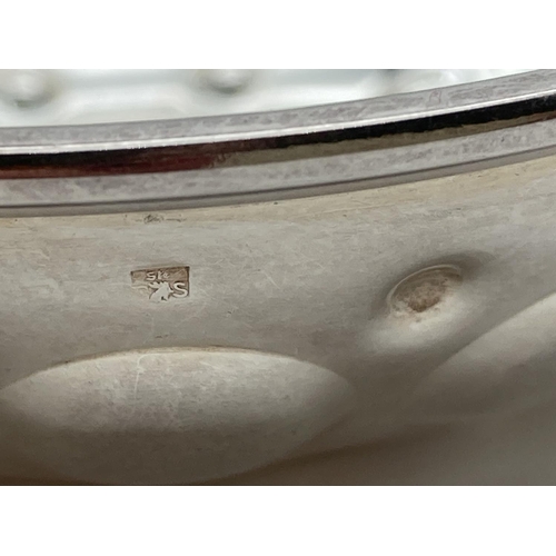 1078 - A French silver wine tasting cup with circular decoration to bowl and ridged detail to curled handle... 