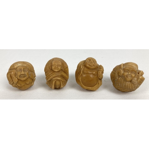 1195 - 4 small carved spherical shaped figures, possibly from nuts. Each modelled as a different figure, ap... 