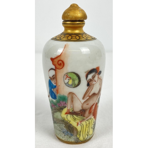 1197 - A small Chinese ceramic snuff bottle with painted erotic scene. Gilt painted stopper and top rim. Ha... 