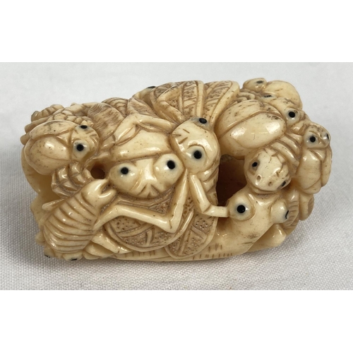 1201 - A carved bone netsuke in the form of a ring of crickets, beetles and bugs. Signature mark to reverse... 