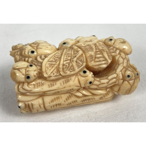 1201 - A carved bone netsuke in the form of a ring of crickets, beetles and bugs. Signature mark to reverse... 