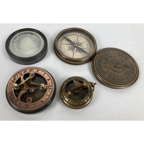 1331 - 3 metal cased compasses. A large brass cased compass with screw top lid featuring a perpetual calend... 