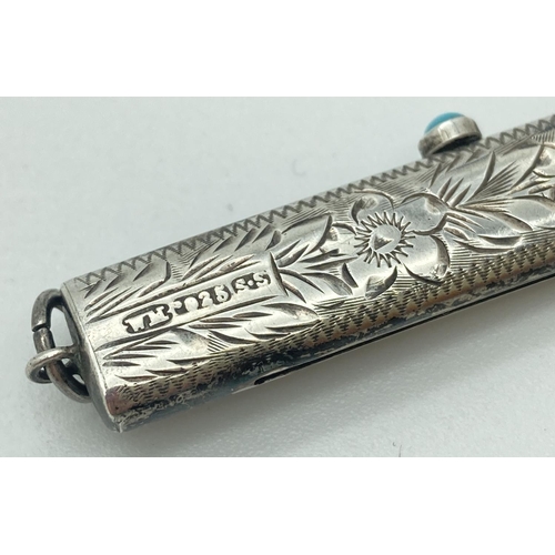 1084 - An antique silver propelling pencil and button hook. Floral engraving throughout with empty cartouch... 