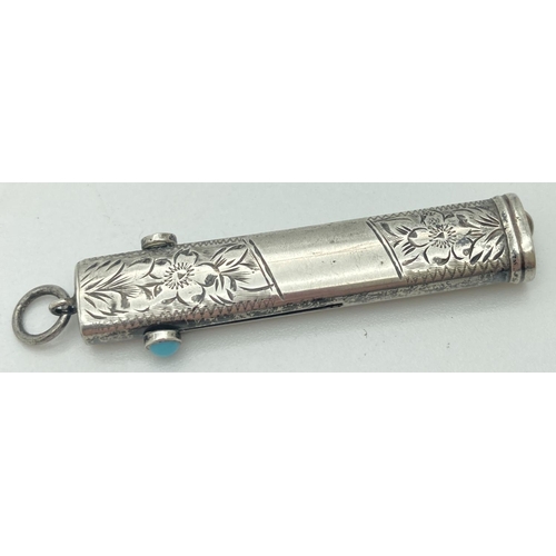 1084 - An antique silver propelling pencil and button hook. Floral engraving throughout with empty cartouch... 