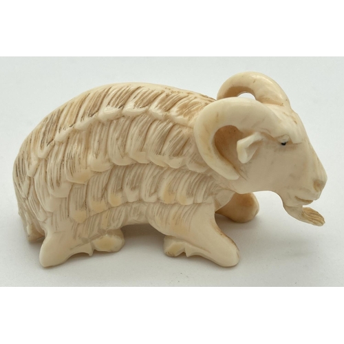 1333 - An Antique carved ivory figure of a long haired ram. Approx. 3.5 x 6cm.