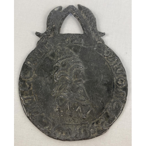 1334 - A medieval style lead medallion with kings heads to each side and wheatsheaf and fish detail to top.... 