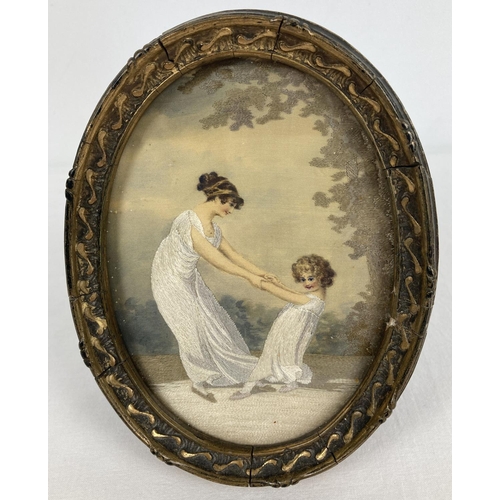 1367 - A gilt framed and glazed oval antique fine embroidery and silk picture depicting a Georgian mother a... 