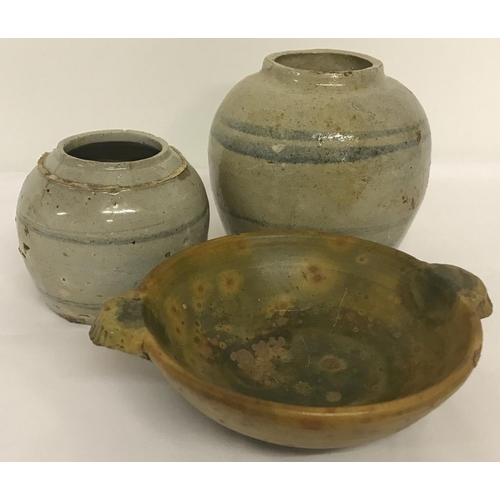 1204 - 3 pieces of Eastern stoneware ceramics. 2 bulbous jars with blue stripe detail together with a 2 han... 