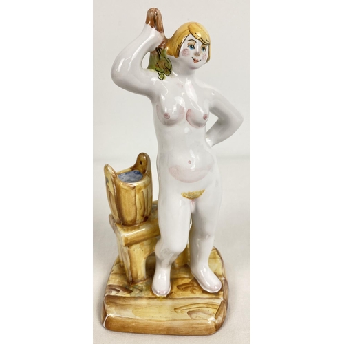 1165 - A Russian pottery nude figurine of a woman in a sauna. Impressed mark to underside, and gilt 'Made i... 