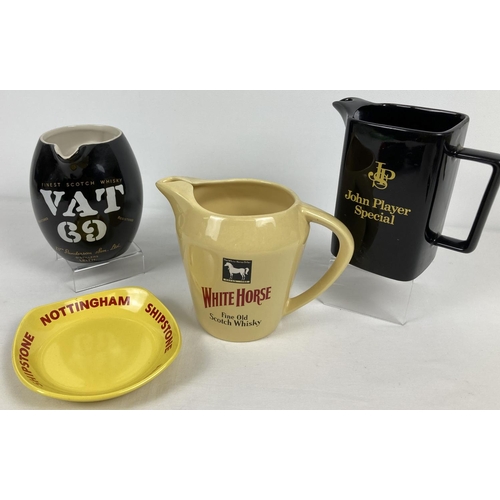 1173 - 4 ceramic brewery advertising items, 3 water jugs and an ashtray. To include 2 Wade items and a Roya... 