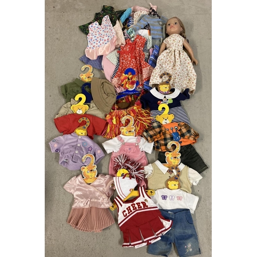 1256 - An Our Generation style vinyl doll with a collection of assorted handmade dolls clothes. Together wi... 