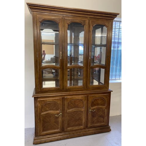 1385 - A large mirror backed, solid wood heavy display unit with glass doors and cupboard base. Base has in... 