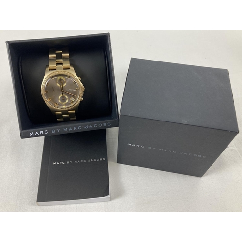 1166 - A boxed ladies Marc By Marc Jacobs MBM3298 chronograph wristwatch. Gold tone bracelet strap with bro... 