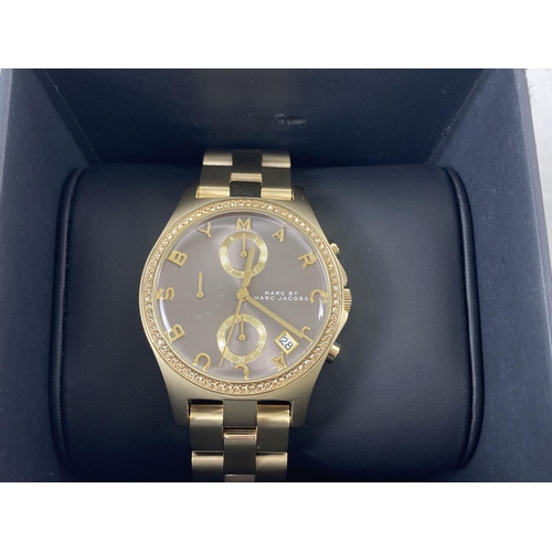 1166 - A boxed ladies Marc By Marc Jacobs MBM3298 chronograph wristwatch. Gold tone bracelet strap with bro... 