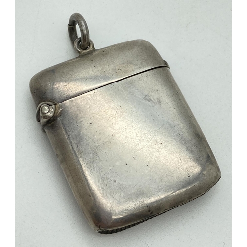 1192 - An Edwardian silver curve backed vesta case hallmarked for G. Loveridge, B'ham 1902. With hanging ba... 