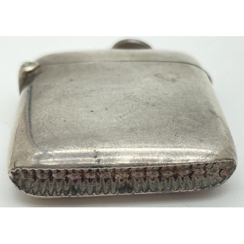 1192 - An Edwardian silver curve backed vesta case hallmarked for G. Loveridge, B'ham 1902. With hanging ba... 