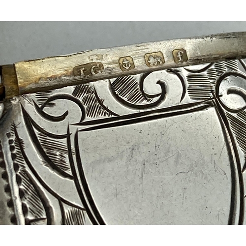 1193 - An Edwardian silver vesta case with engraved foliate & scroll detail front & back. Central empty shi... 