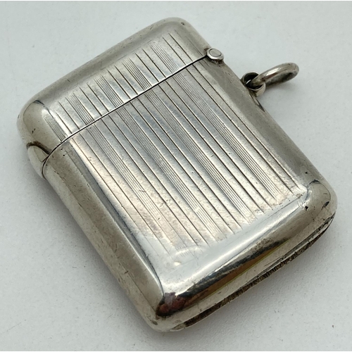 1194 - A Sampson Mordan & Co Edwardian silver 'Seamless' vesta case. With engine turned chanelled detail fr... 