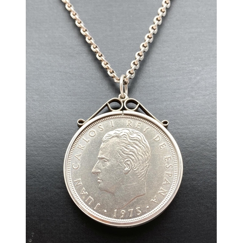 1093 - A silver Spanish 100 Ptas 1974 coin, in silver mount. On a 20 inch decorative belcher chain with spr... 