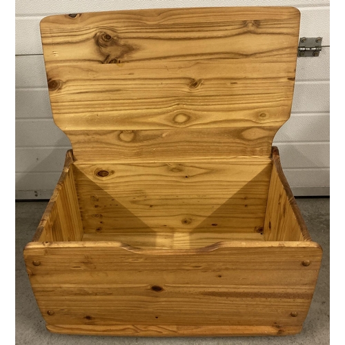 1399 - A vintage pine storage box with hinged lid and bun feet. Approx. 38cm x 72.5cm x 46cm.