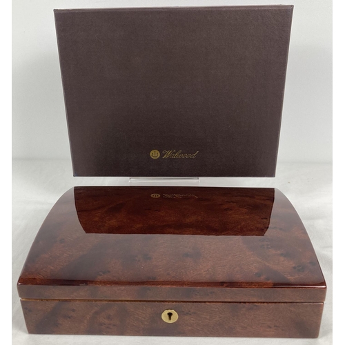 1067 - A new and boxed red Birdseye maple jewellery box by Walwood. Cream velveteen lining with ring/earrin... 