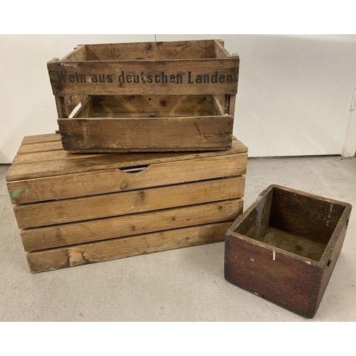 1401 - 3 vintage wooden boxes. To include a pine slatted box with hinged lid and a German advertising crate... 