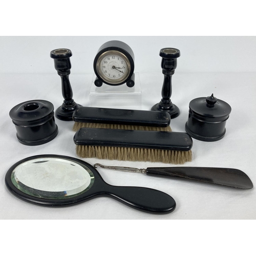 1355 - A vintage 9 piece ebony dressing table set. Comprising: a pair of candlesticks, clock, 2 x clothes b... 