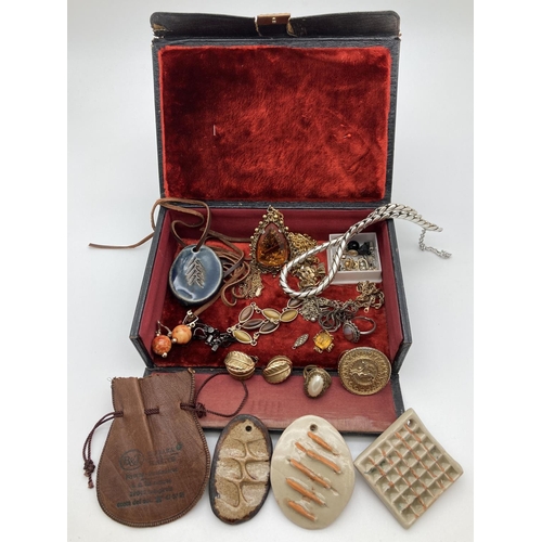 1083 - A vintage red silk & velvet lined leather jewellery box and contents. To include costume jewellery r... 