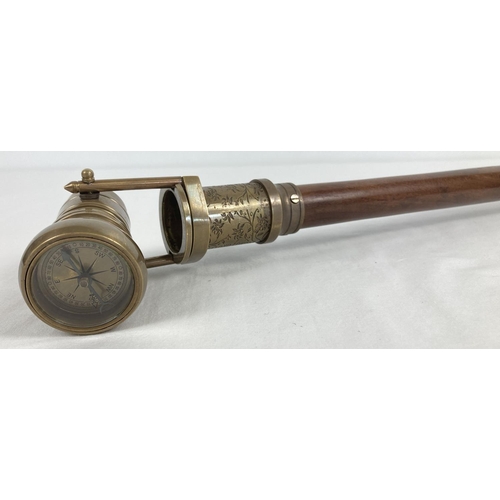 1363 - A reproduction wood and brass walking stick with swivel top telescope/compass handle. Approx. 95.5cm... 