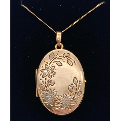 1108 - A 9ct gold oval shaped locket on an 18