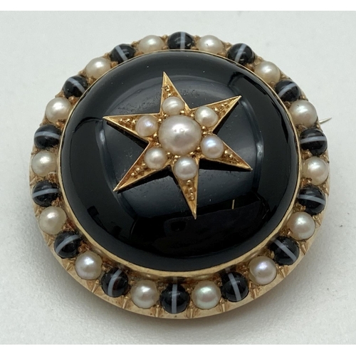 1001 - A Victorian gold mourning brooch with black enamelled central panel and set with seed pearls. Revers... 